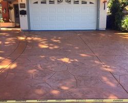 stamped concrete colored terra cotta driveway installation
